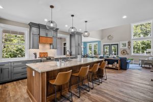 The interior design of a beautiful kitchen with a large island in a modern new England colonial home